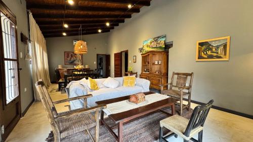 a living room with a couch and a table and chairs at Casa Boutique con piscina y cercana a plaza de Villa de las Rosas in Villa de Las Rosas