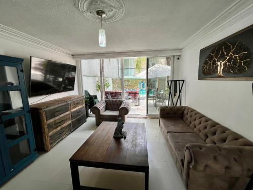 a living room with a couch and a table at 3 VENATOR House Boutique in León