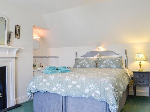 a bedroom with a bed with blue towels on it at St Enodoc in Ullapool