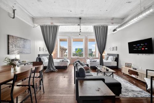a living room with a couch and a table at Stunning Downtown Apartment with Pool, Laundry, Parking in Dallas