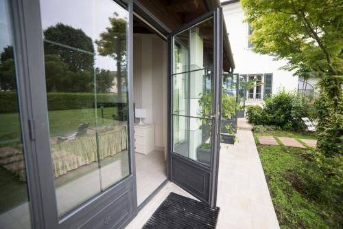a glass door to a house with a yard at Villa Franca in Franciacorta in Passirano