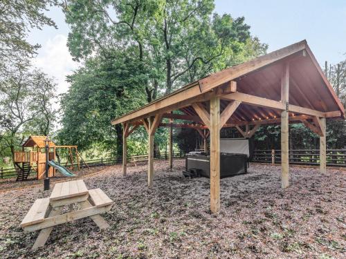 a pavilion with a picnic table and a playground at Groudd Hall in Cerrigydrudion