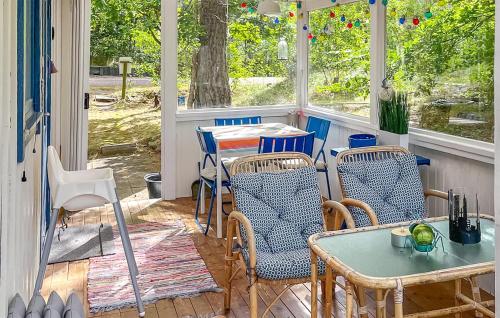 a patio with a table and chairs on a porch at 3 Bedroom Gorgeous Home In Mellbystrand in Mellbystrand