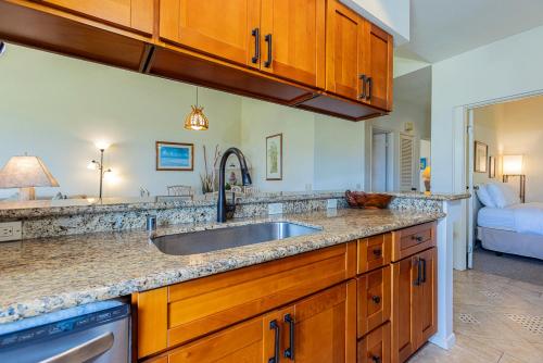 a kitchen with a sink and a bed in a room at Grand Champions 170 by Coldwell Banker Island Vacations in Wailea