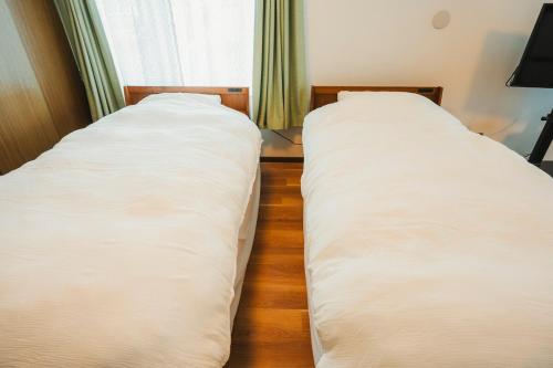 Una cama o camas en una habitación de 杉 by Cabin Build