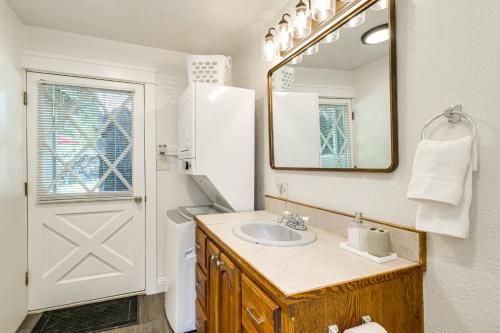 a bathroom with a sink and a mirror and a door at Gateway to Crater Lake Cabin in Klamath Falls! in Rocky Point