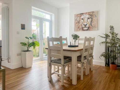 a dining room with a table and four chairs at Hill View in Abertillery
