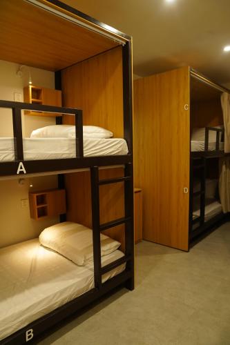 a room with two bunk beds in a room at Hanoi Wanderlust Hostel & Travel in Hanoi