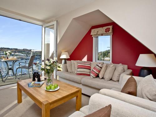 a living room with a couch and a table at Woodbine House in Kingswear