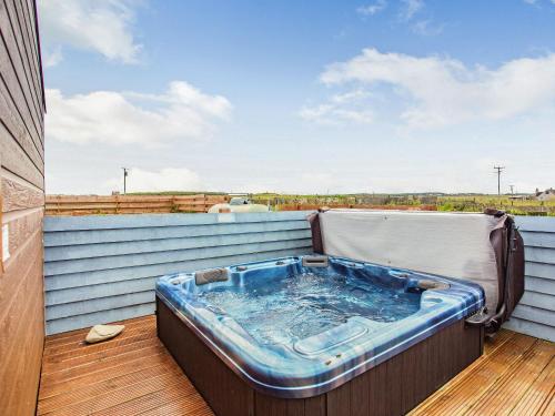 a hot tub on the balcony of a house at Swona in Mey