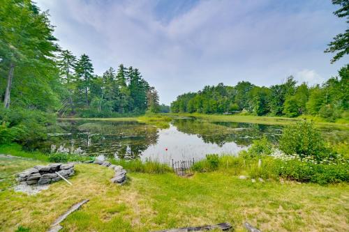 a large pond with trees in the background at Lake Access and Views Peaceful Getaway in Conway in Conway