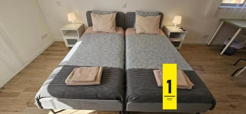a large bed in a room with a yellow tag on it at Ideal Bubble House in Faro