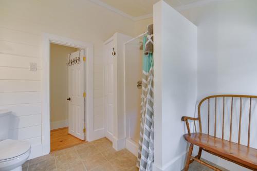 a bathroom with a toilet and a wooden bench at Lake Access and Views Peaceful Getaway in Conway in Conway