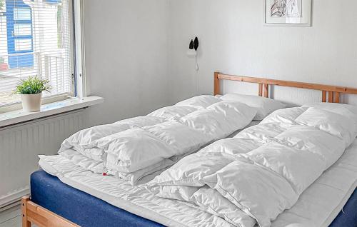 an unmade bed in a room with a window at 3 Bedroom Gorgeous Home In Mellbystrand in Mellbystrand