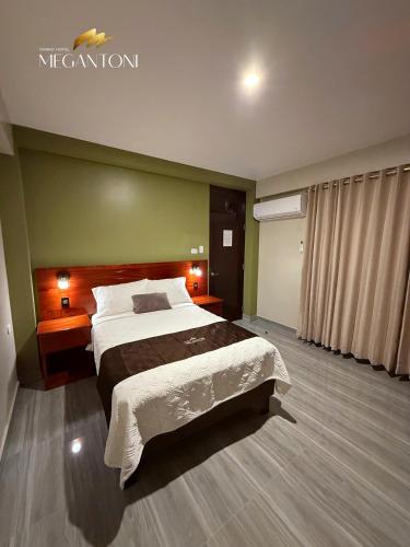 a bedroom with a large bed in a room at Grand Hotel Megantoni in Quillabamba