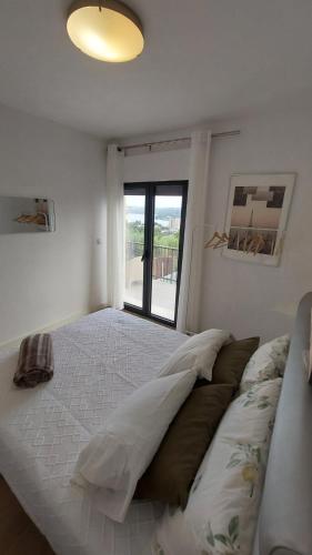 a bedroom with a large bed with a window at RIVER VIEW TMB oporto station house in Porto