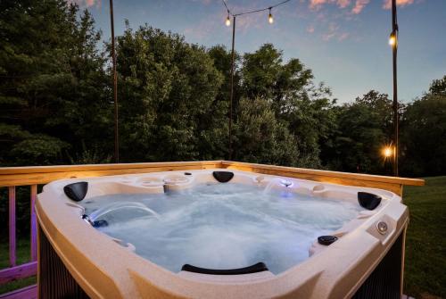 a jacuzzi tub sitting on top of a yard at Epic Family Stay - 40' Putting Green, Theater, Hot Tub, Sauna in McGaheysville