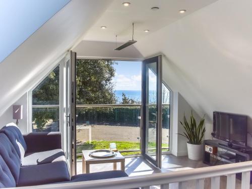 a living room with a large sliding glass door at Sunny South Lodge in Sandown
