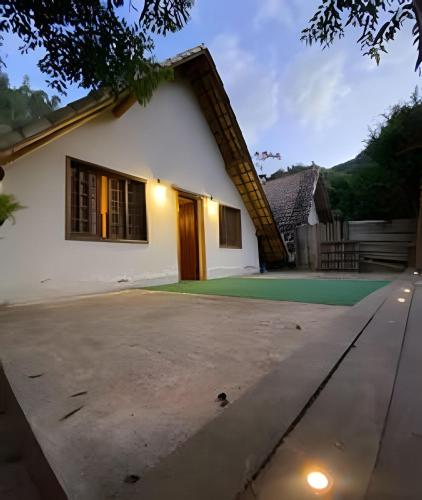 a house with a driveway in front of it at Chalé Montserrat com Lareira e Vista para as Montanhas in Nova Friburgo
