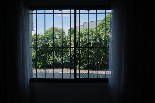 an open window with a view of a garden at Apartahotel Poblado-Aguacatala in Envigado