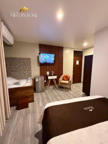 a hotel room with a bed and a tv at Grand Hotel Megantoni in Quillabamba
