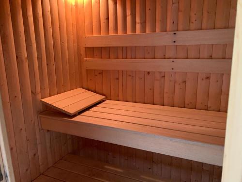a wooden sauna with a wooden bench in it at Eversfield in Goathland