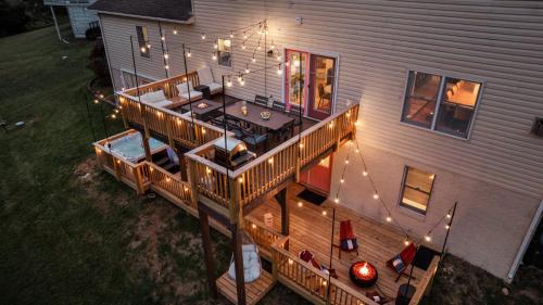 an overhead view of a house with a deck with lights at Epic Family Stay - 40' Putting Green, Theater, Hot Tub, Sauna in McGaheysville