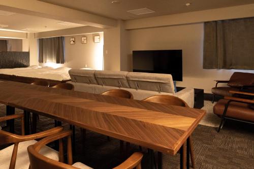 a conference room with tables and chairs and a flat screen tv at Otakihashi Pacifica Building in Tokyo