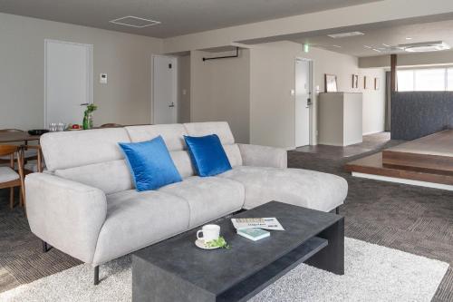 a living room with a couch and a table at Otakihashi Pacifica Building in Tokyo