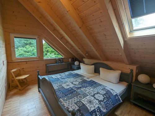 a bedroom with a bed in a log cabin at Borner Holzhaus in Born
