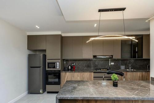 a kitchen with a island in the middle of it at Madinaty B8 Lux Stay 1 in Cairo