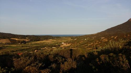 a view of a valley with mountains in the distance at Majori in Fluminimaggiore