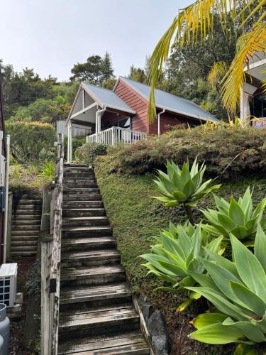 a set of stairs leading up to a house at Sunset View Chalet in Paihia