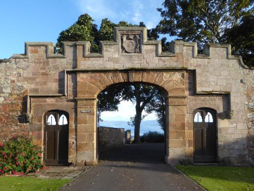 an entrance to a stone building with an archway at Crail House in Crail