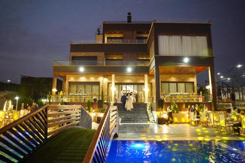 a house with a swimming pool in front of it at Kinda vip in Al Mashāriqah