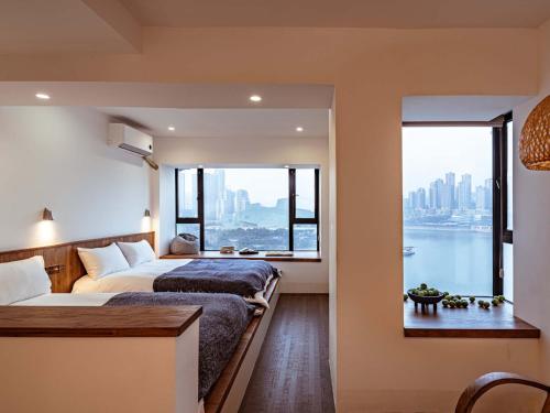 a bedroom with two beds and a large window at Boys2men in Chongqing