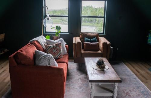 a living room with a couch and a coffee table at The Eyrie, your private Ocean View apartment in Head of Jeddore