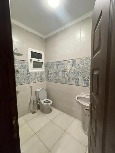 a bathroom with a toilet and a sink at الاسكندريه كينج مريوط in King Mariout