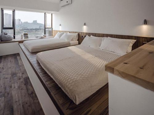 two beds in a room with a counter at Boys2men in Chongqing