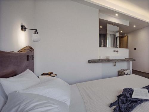 a bedroom with a white bed and a mirror at Boys2men in Chongqing