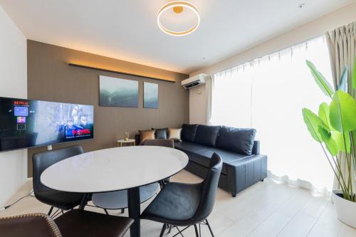 a living room with a table and a couch at Frieden Haus in Tokyo