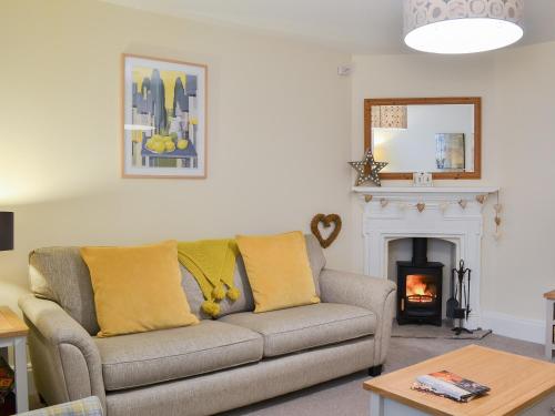 a living room with a couch and a fireplace at Princess Lodge in Scarborough