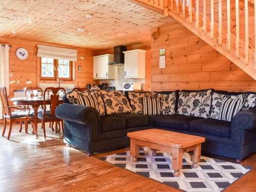 a living room with a couch and a table at Foxglove- Uk48308 in Staintondale