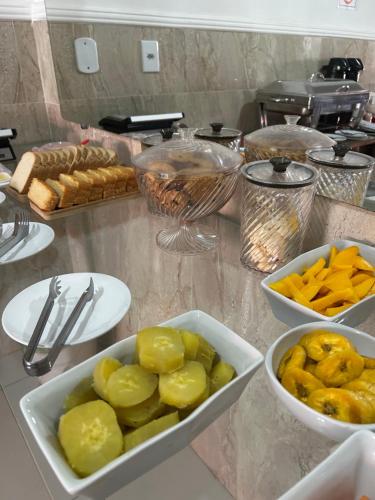 a counter with several bowls of food on a table at Pousada Oliveira in Remanso