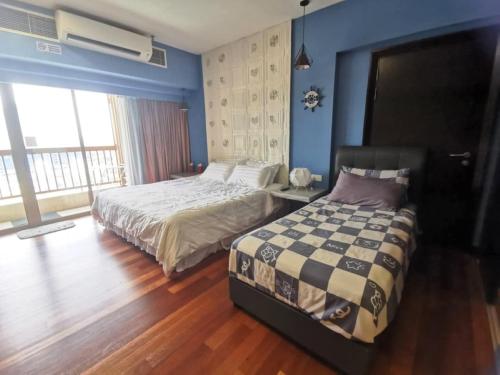 a bedroom with a bed and a large window at Resort Suites Pyramid & Lagoon in Petaling Jaya