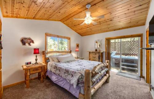 a bedroom with a bed and a wooden ceiling at Wren's Nest and Hot-Tub, Games with Best Location! in Big Bear Lake