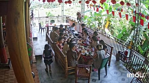 a group of people sitting at a table in a restaurant at House By The Stream in Lũng Tiềm