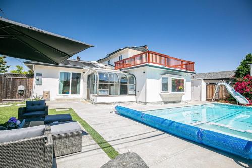 a home with a swimming pool and a house at Fun 3BR with Pool & Slide, Pet Friendly in San Jose in San Jose