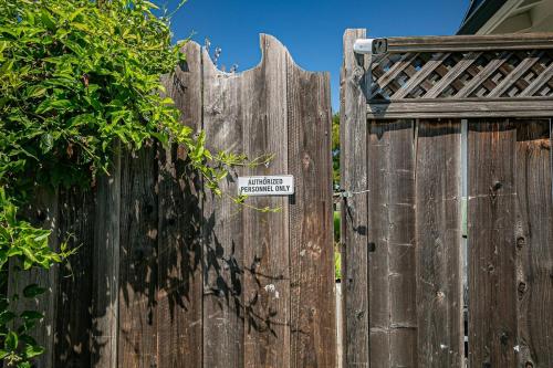 a wooden fence with a sign on it at Fun 3BR with Pool & Slide, Pet Friendly in San Jose in San Jose