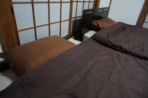 a bedroom with two beds in a room at KAMADOBA glamping in Tōganemachi